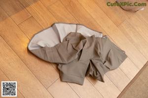 A pair of pants sitting on a wooden floor.