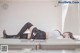 A woman laying on top of a table in a room.