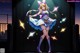 Anime girl in a blue dress and purple boots standing on a stage.