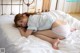 A little girl laying on top of a bed.